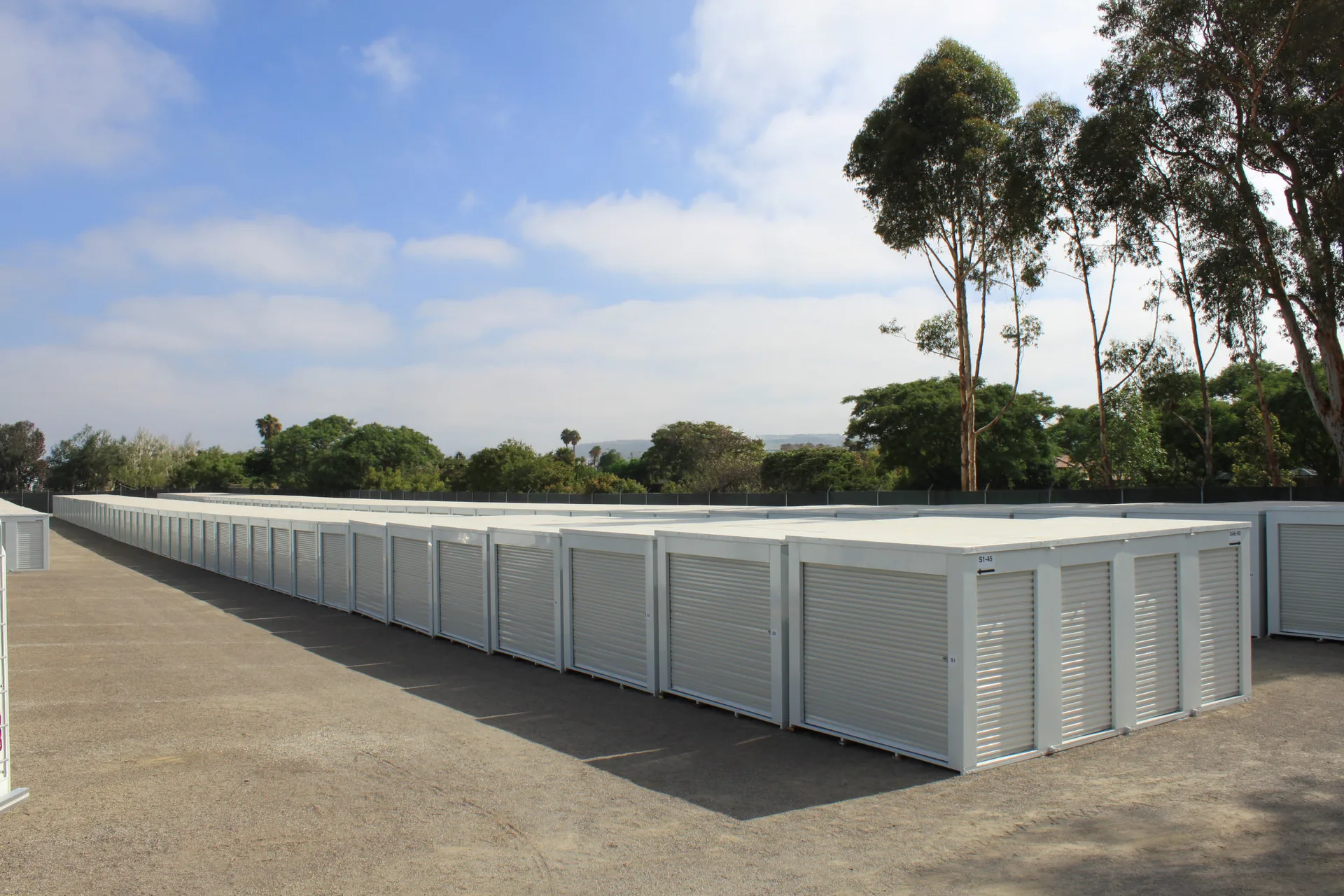 Rows of white storage containers at an outdoor facility