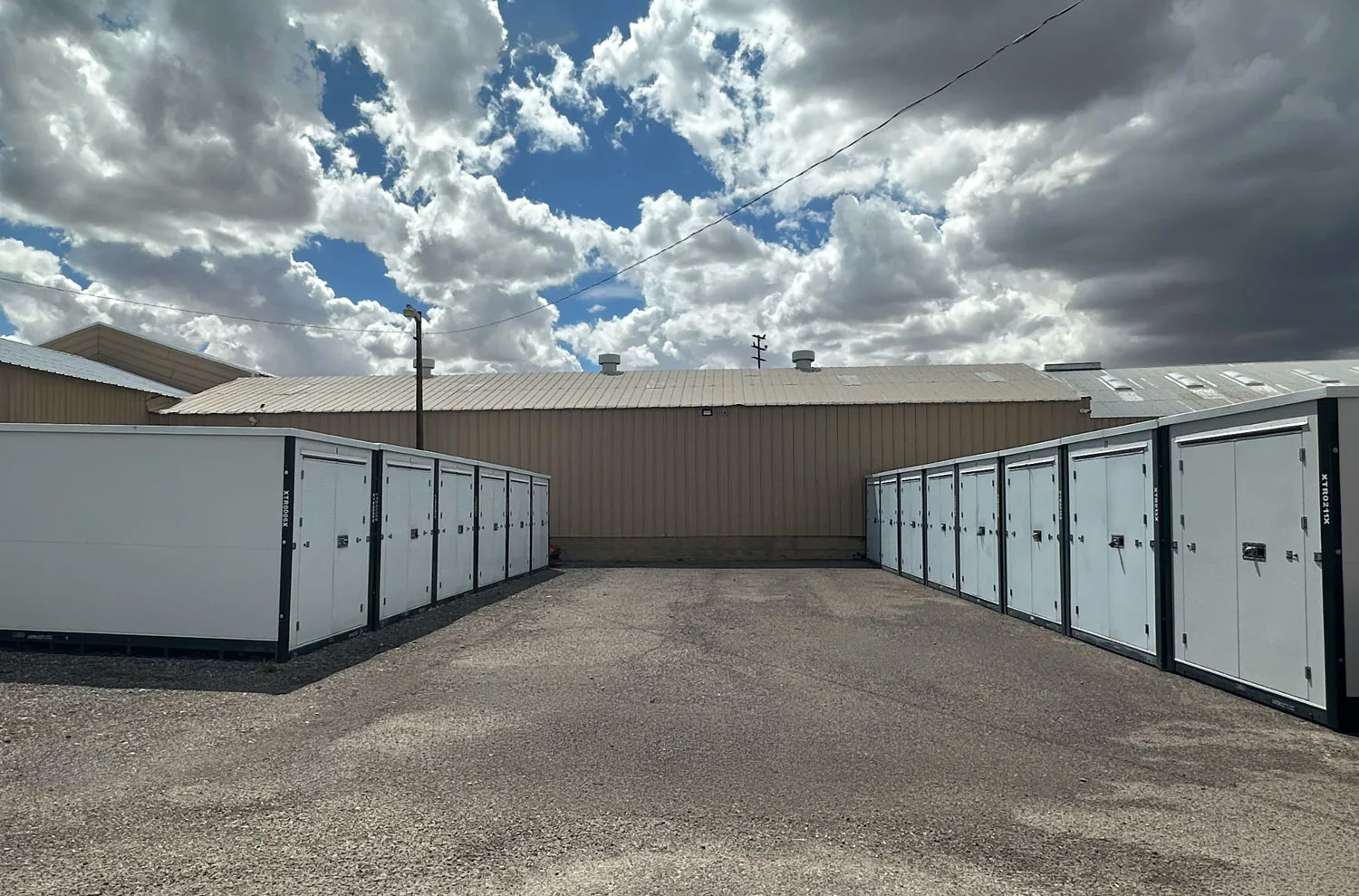 Storage containers beneath a dramatic cloudy sky