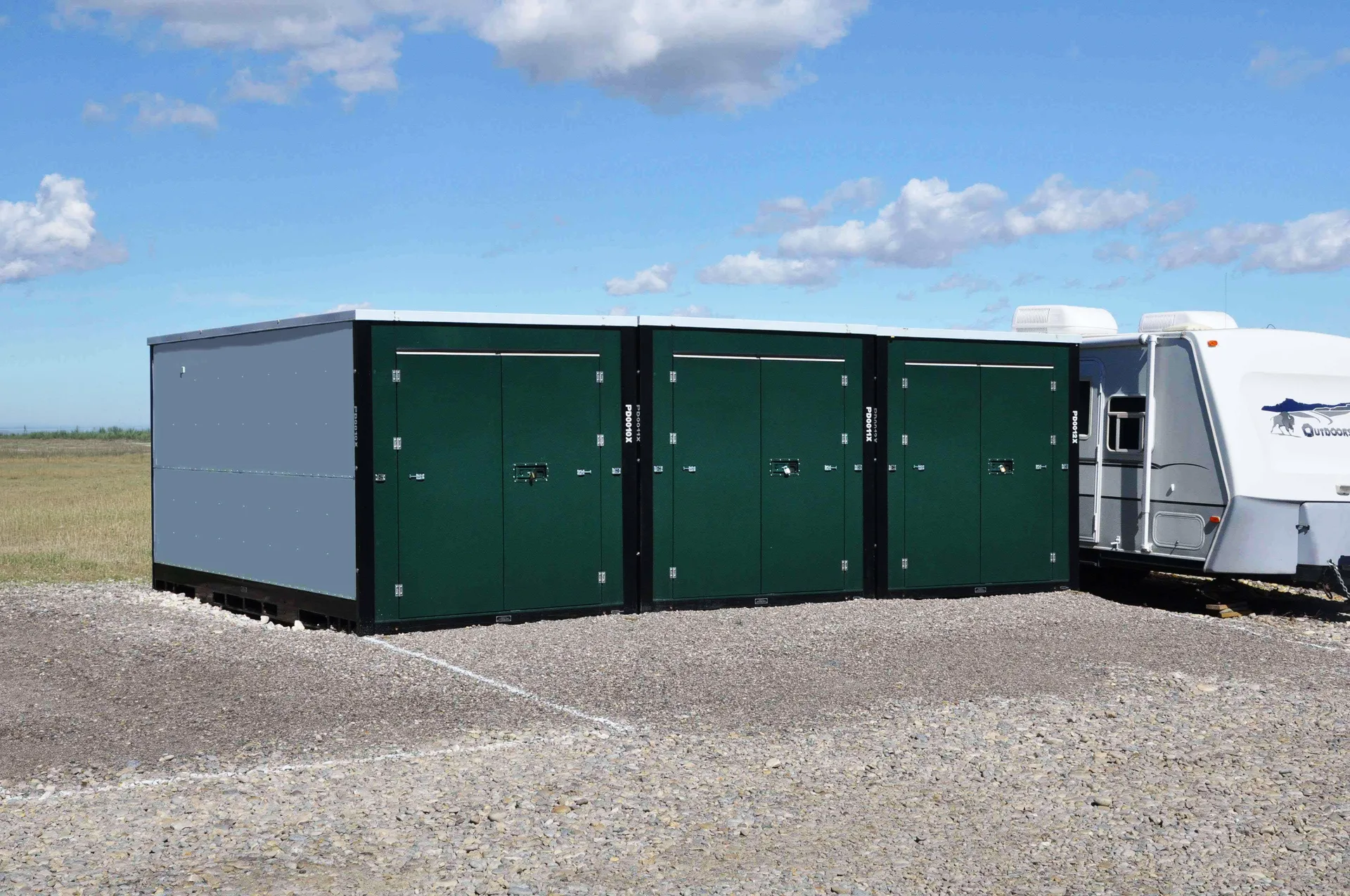 Green storage containers beside a recreational vehicle